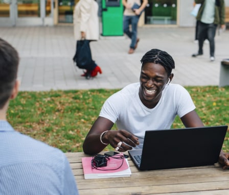 Student on computer outside on college campus